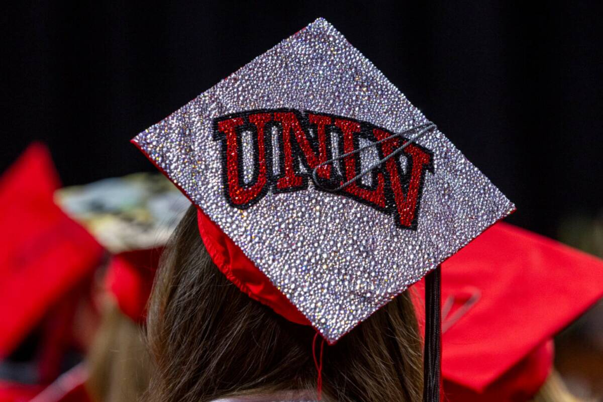 A graduate wears a custom mortar board during UNLV spring graduation commencement exercises at ...
