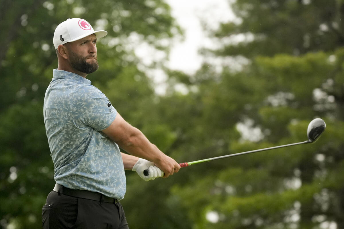 Jon Rahm, of Spain, watches his tee shot on the fifth hole during a practice round for the PGA ...