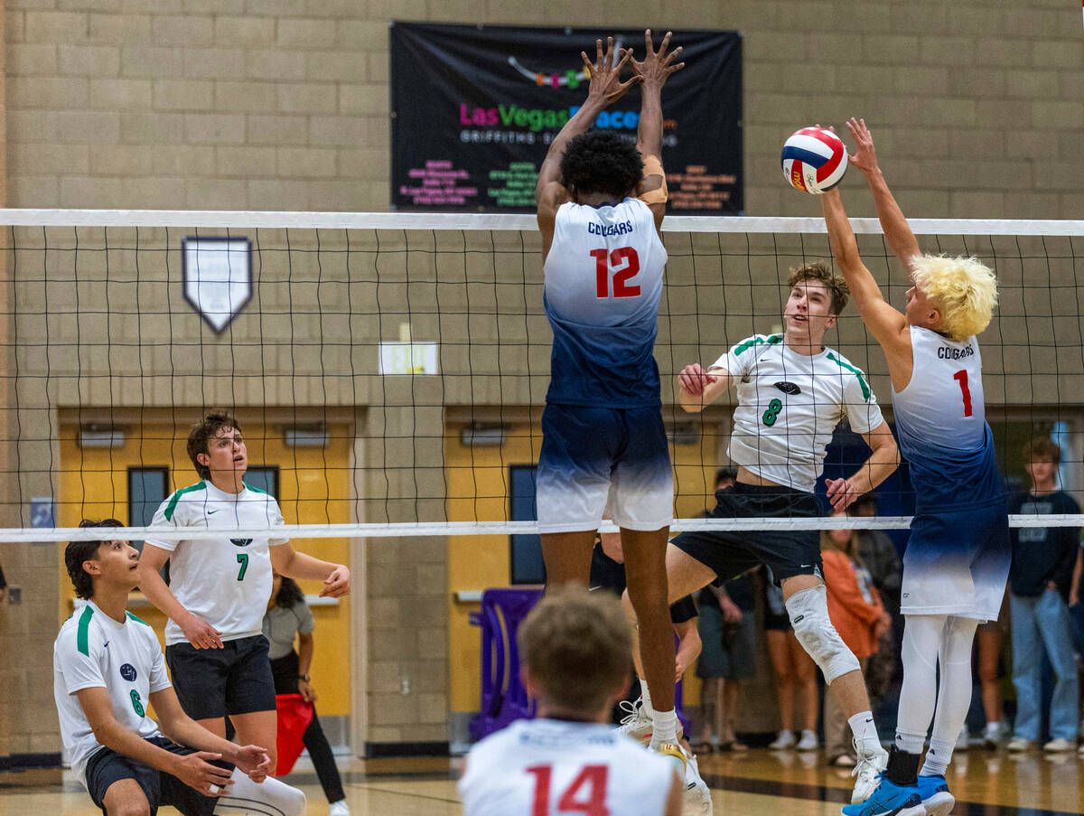 Palo Verde's Cole Manning (8) spikes the ball pasty Coronado's Jayden Bell (12) and Braxton Row ...