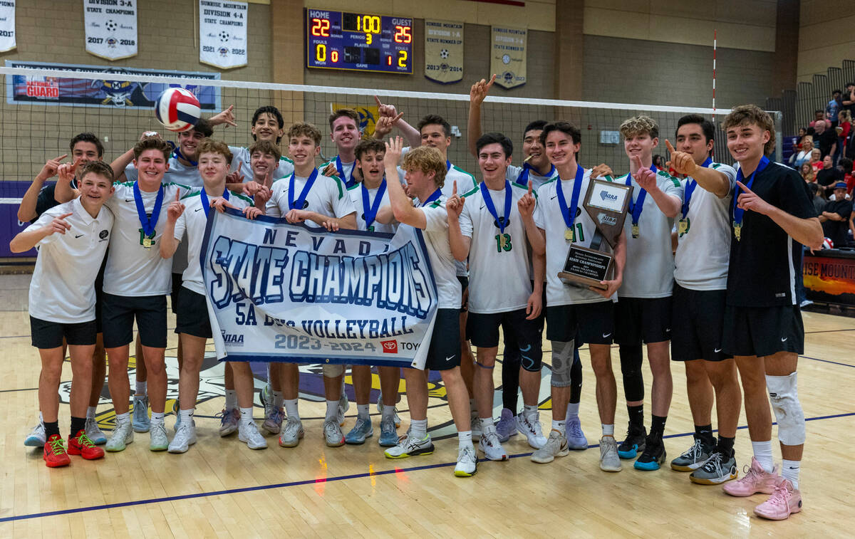 Palo Verde's players celebrate with a banner and the trophy after their match win against Coron ...