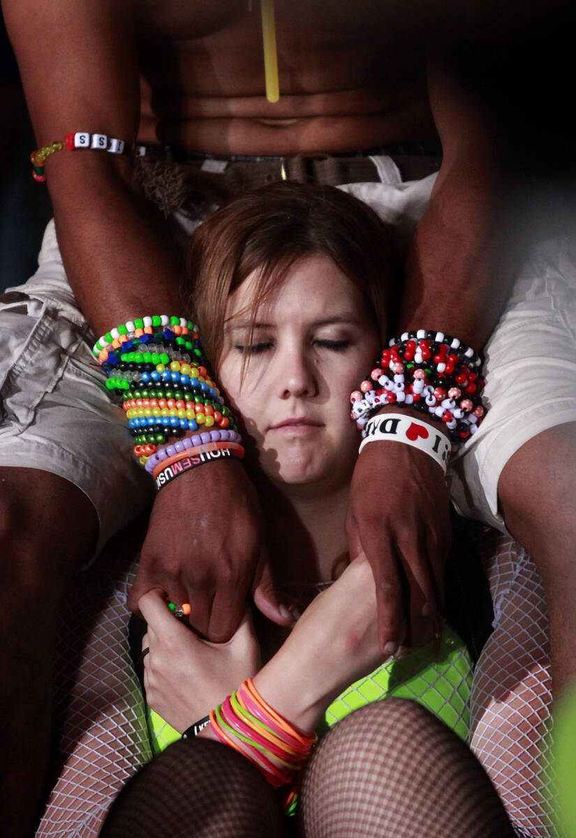 A woman takes a break during the Electric Daisy Carnival at the Las Vegas Motor Speedway in Las ...