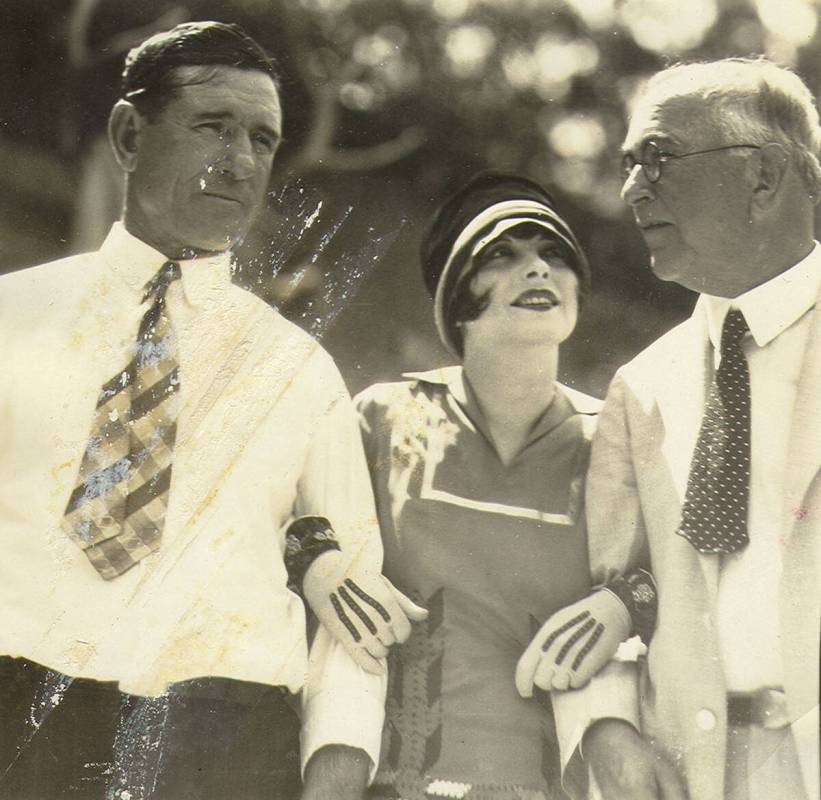 Clara Bow, center, with unidentified men in a photo from UNLV Special Collections’ “Walking ...