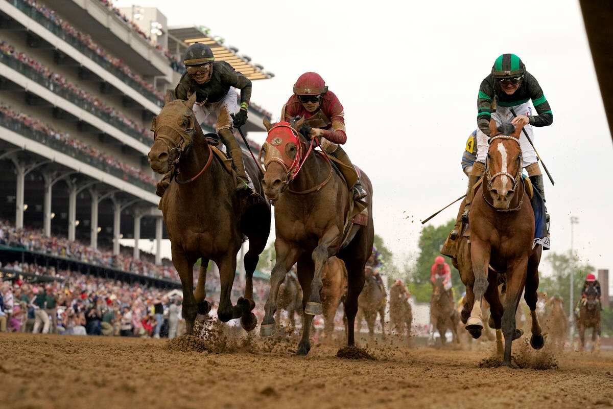Brian Hernandez Jr. rides Mystik Dan, right, to the finish line to win the 150th running of the ...