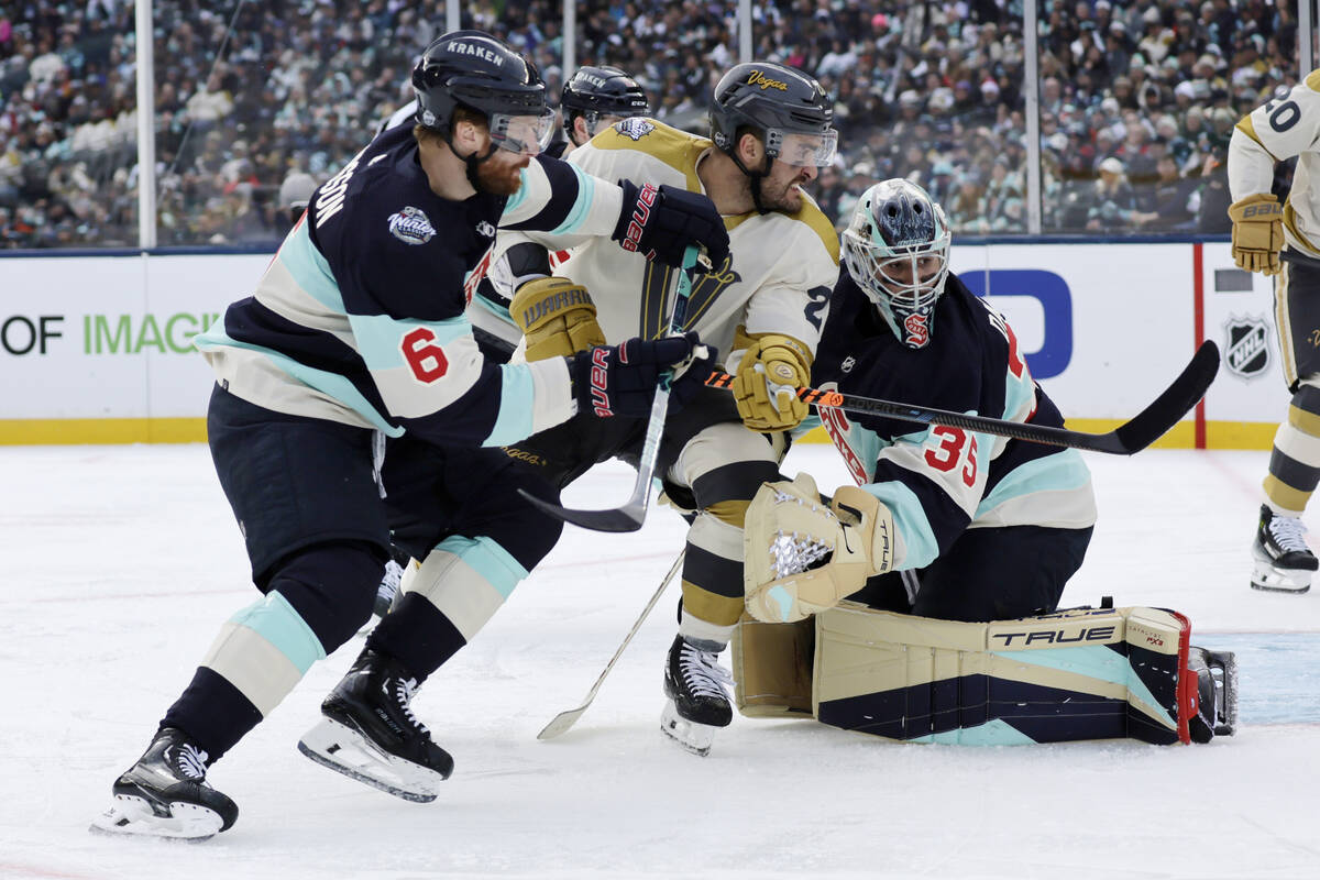 Vegas Golden Knights left wing William Carrier tries to work his way past Seattle Kraken defens ...