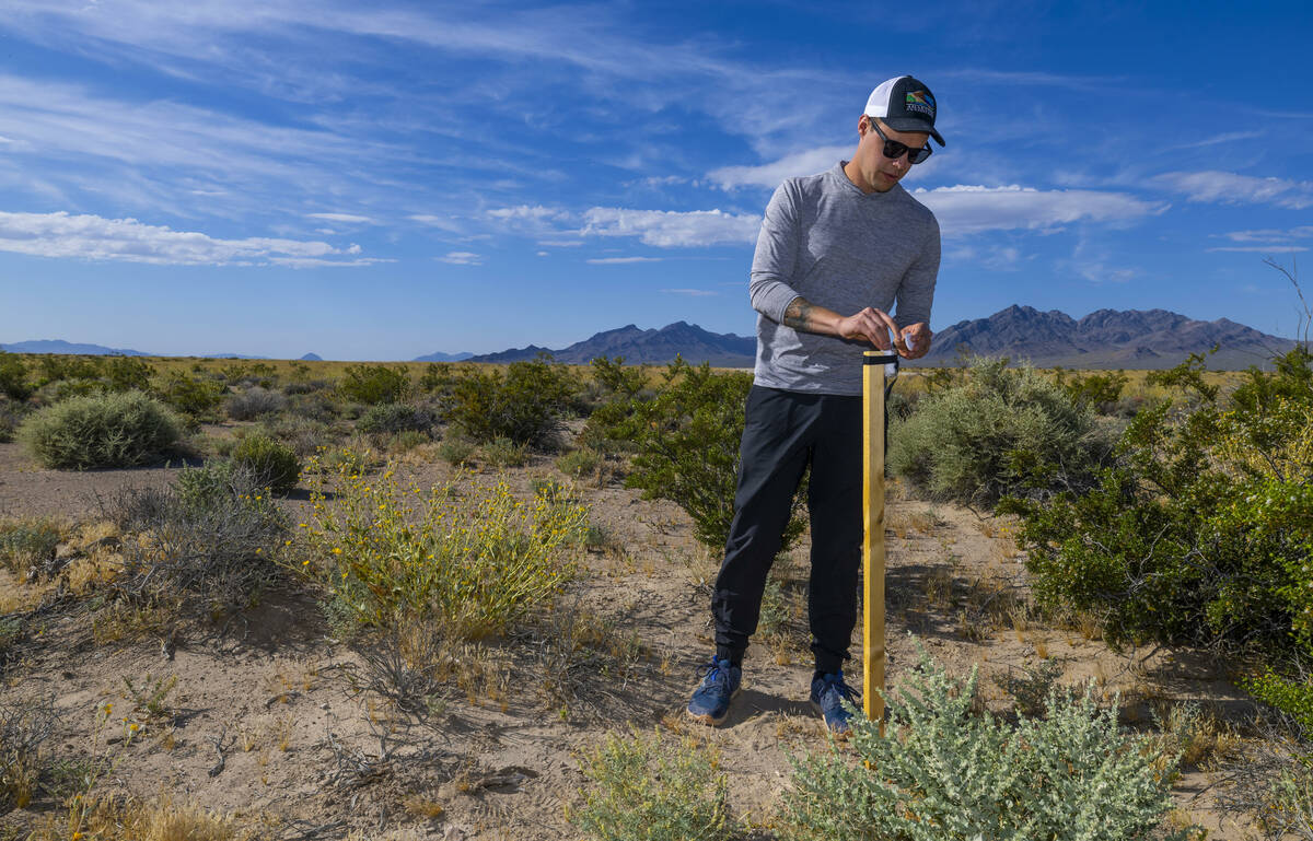 Mason Voehl, executive director of the Amargosa Conservancy, unfurls one of hundreds of mining ...