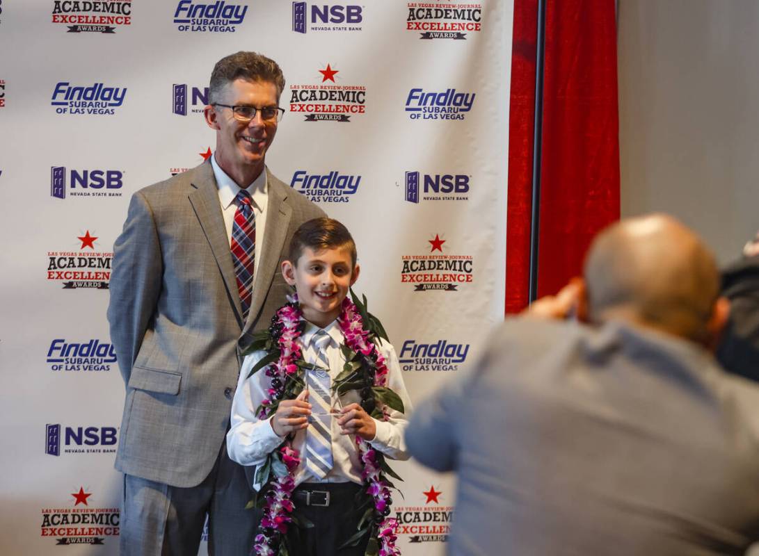 Review-Journal’s Executive Editor Glenn Cook takes a photo with Carson Sheridan, winner ...