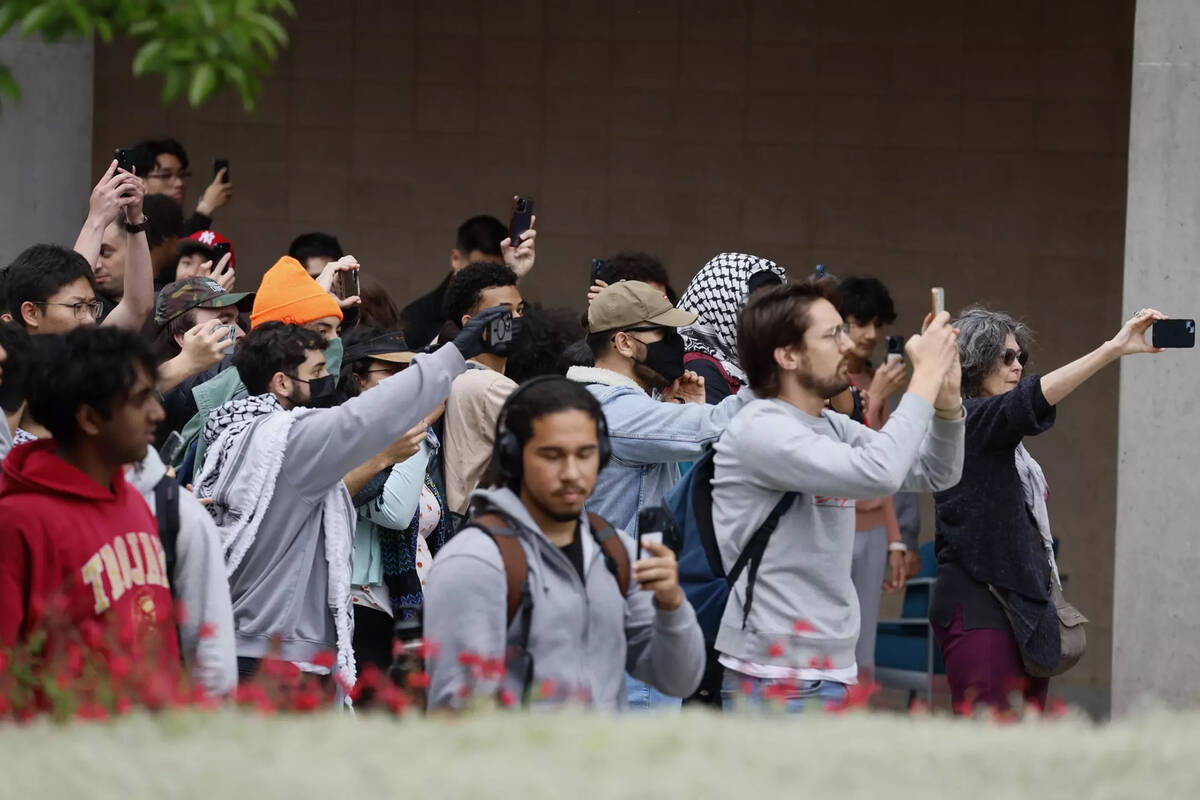 Onlookers film as police descend on the campus at the University of California, Irvine, on Wedn ...