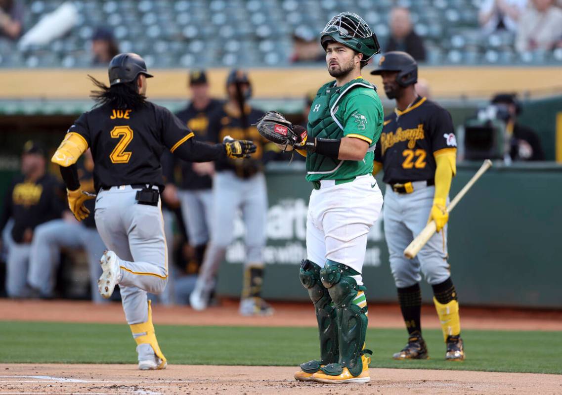 Oakland Athletics' Shea Langeliers looks away as Pittsburgh Pirates' Connor Joe crosses home pl ...