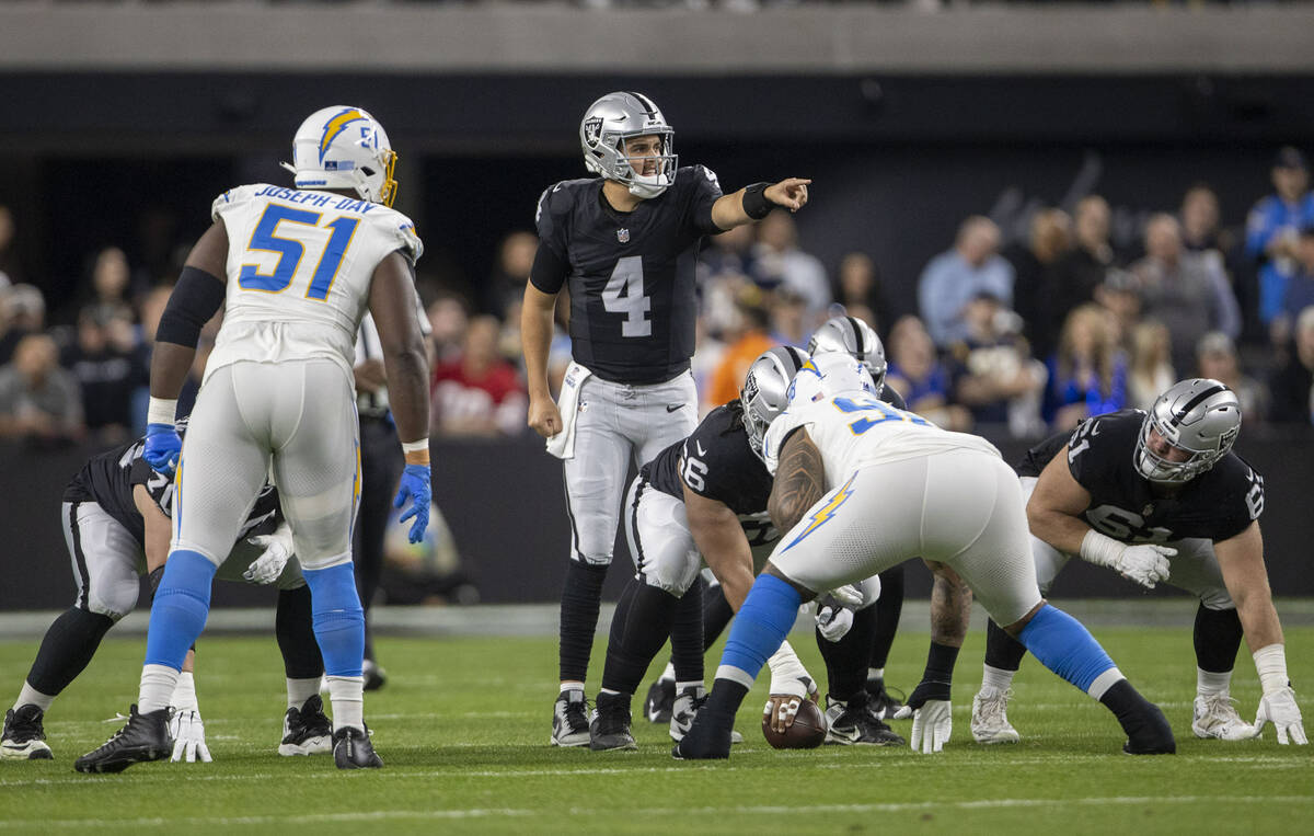 Raiders quarterback Aidan O'Connell (4) audibles at the line of scrimmage during the first half ...