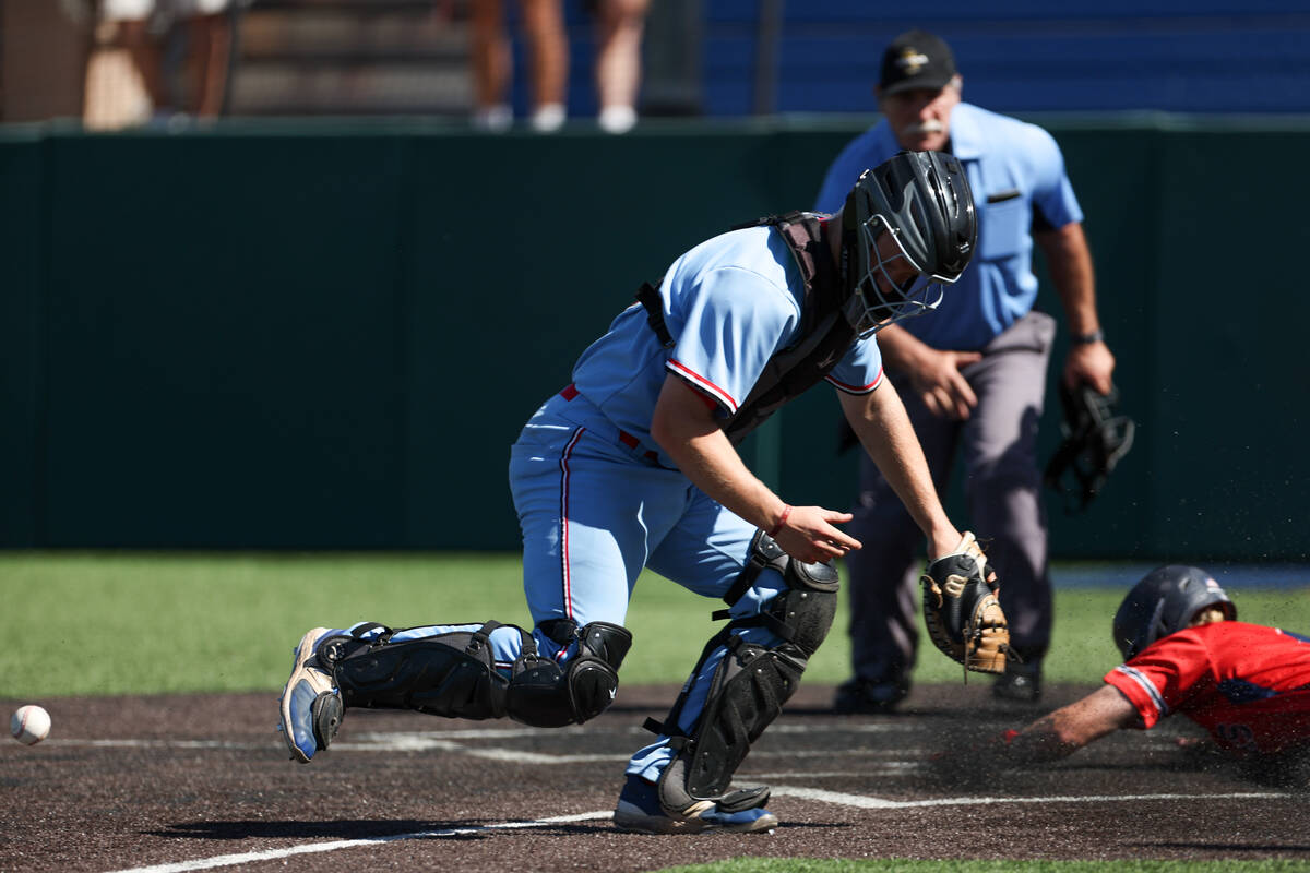 Reno catcher Hunter Garrett (15) misses a catch while Coronado pitcher Evan Festa, right, slide ...