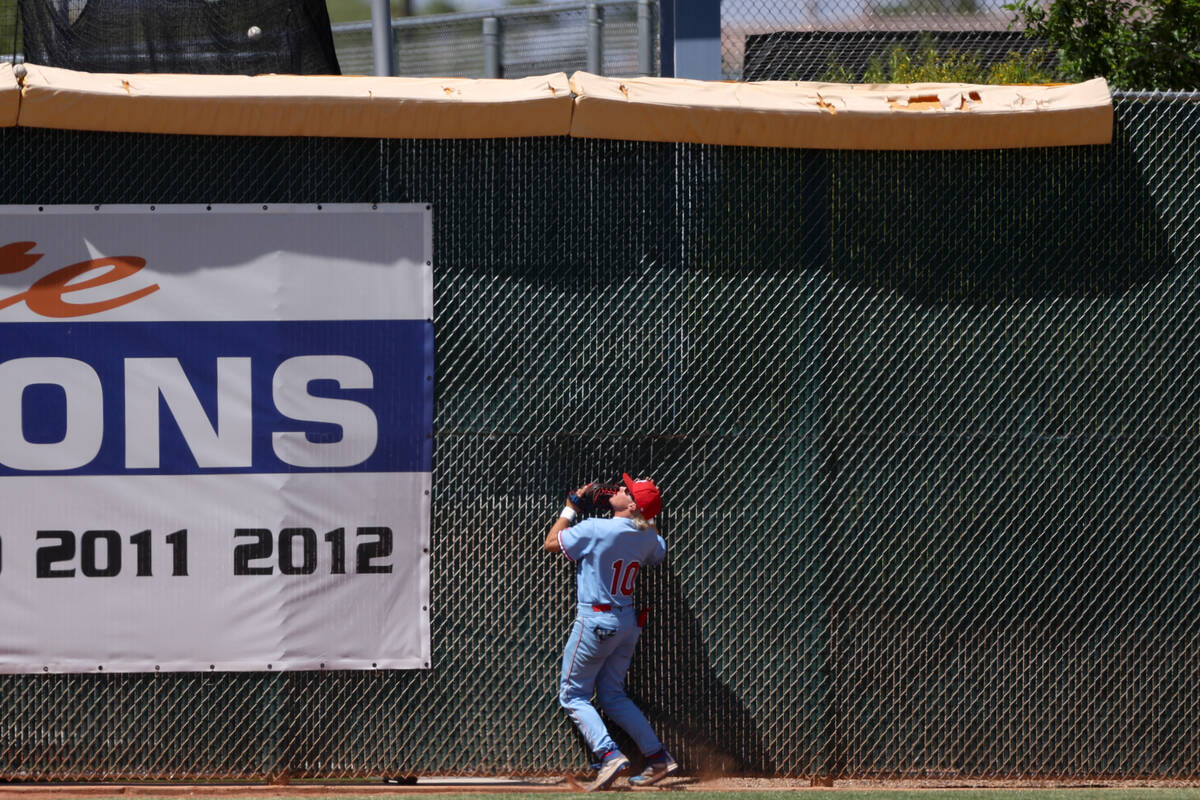 Reno outfielder Jaydon Loose (10) hits the fence while Coronado infielder Matthew Moreno Jackso ...