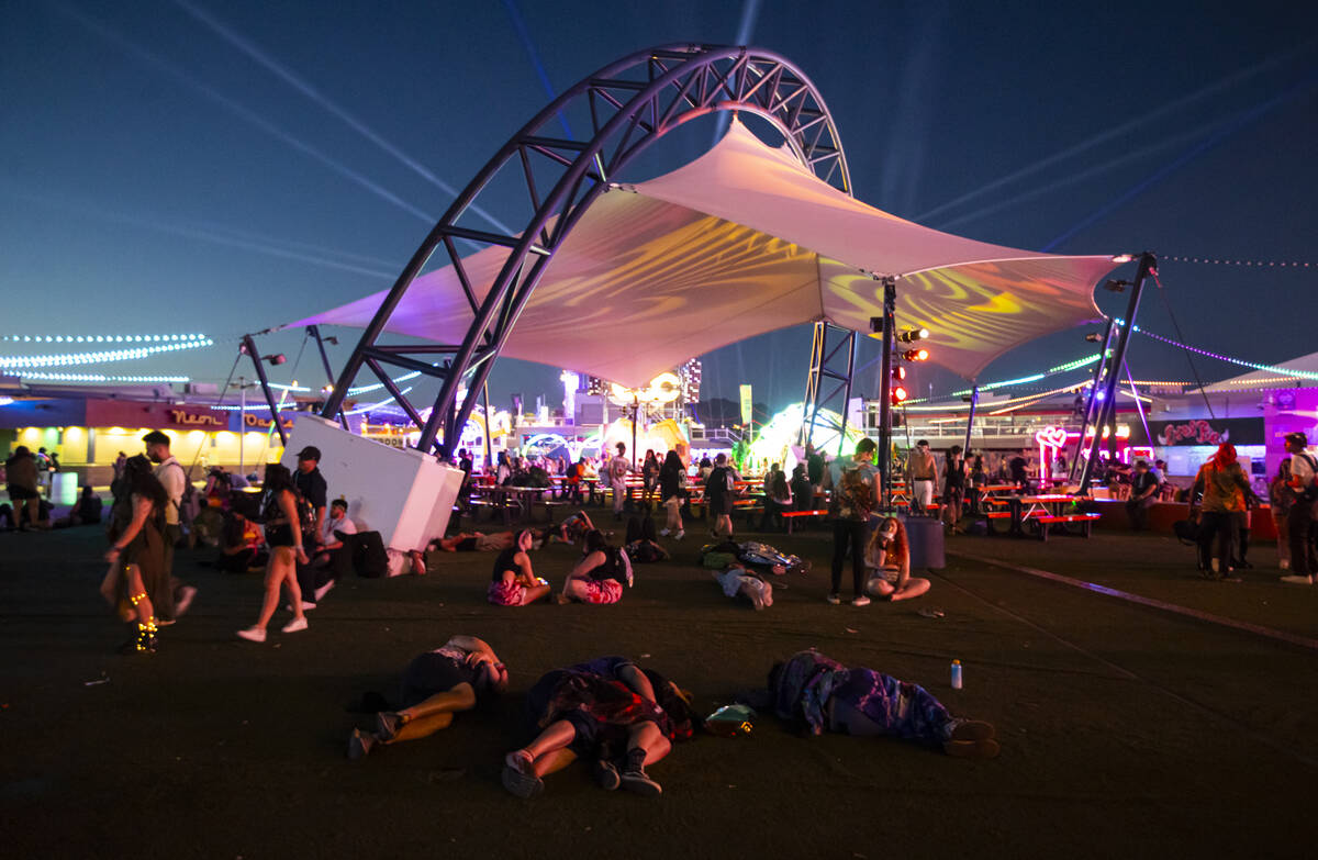 Festival attendees relax as the sun begins to rise during the second night of the Electric Dais ...