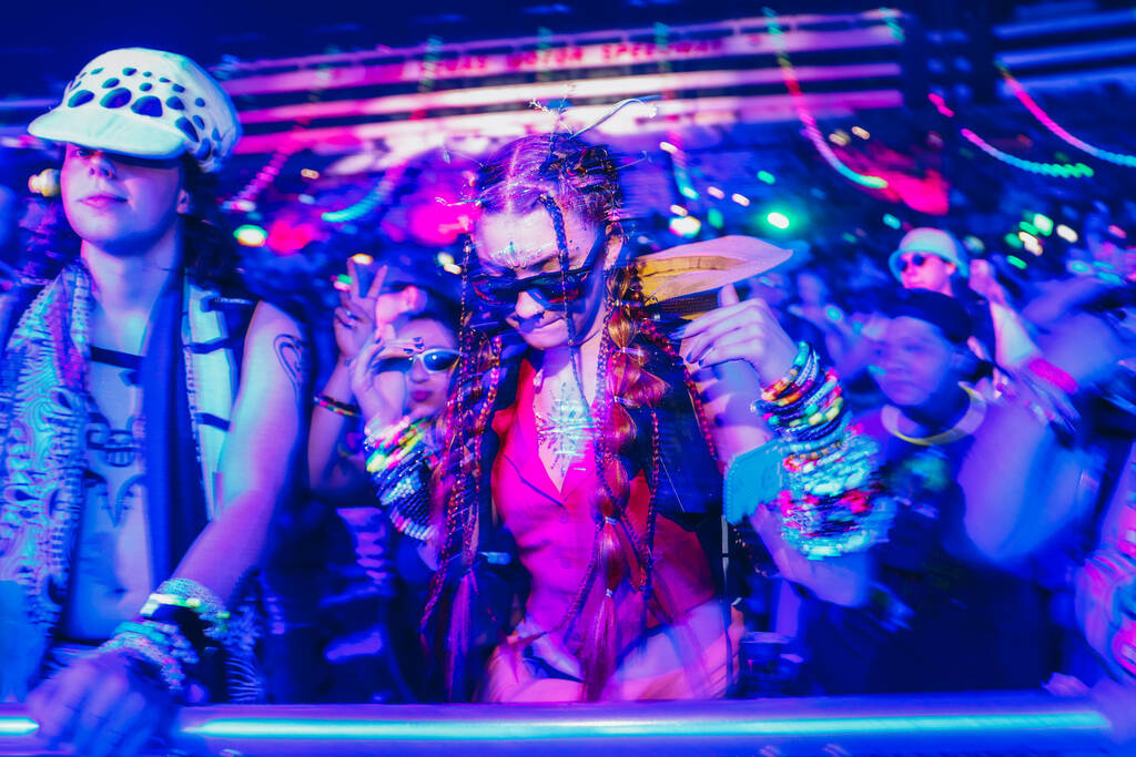 Festival attendees dance to a DJ set during the second day of the Electric Daisy Carnival at th ...