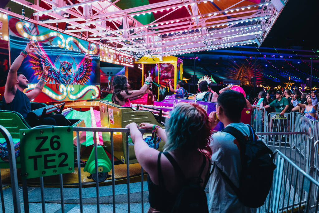 Festival attendees ride an attraction during the second day of the Electric Daisy Carnival at t ...