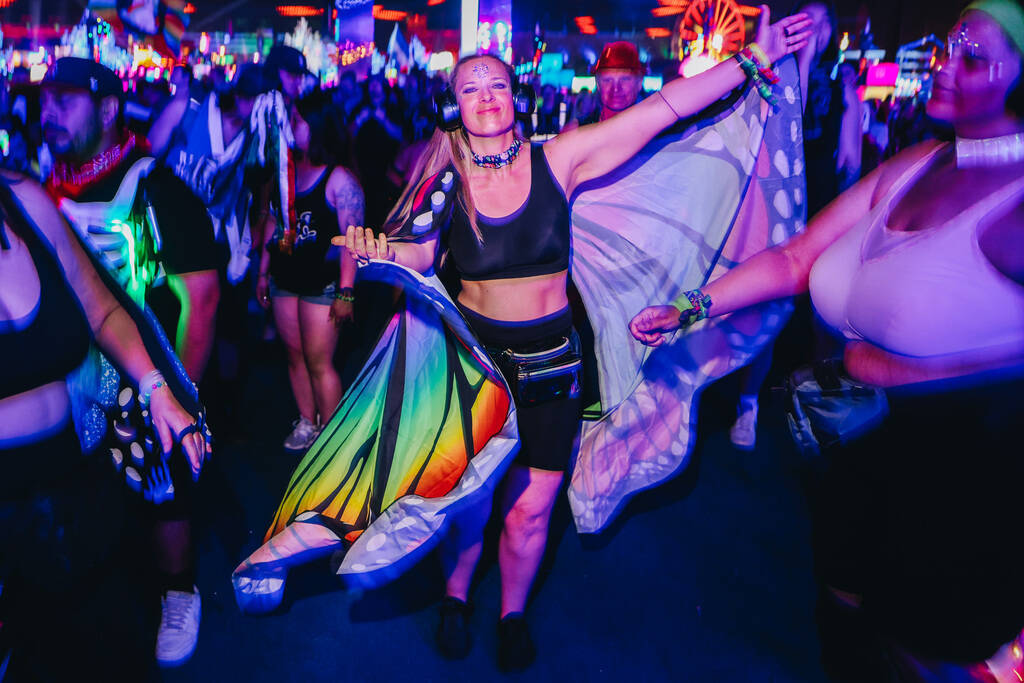 Festival attendees dance to a DJ set during the second day of the Electric Daisy Carnival at th ...