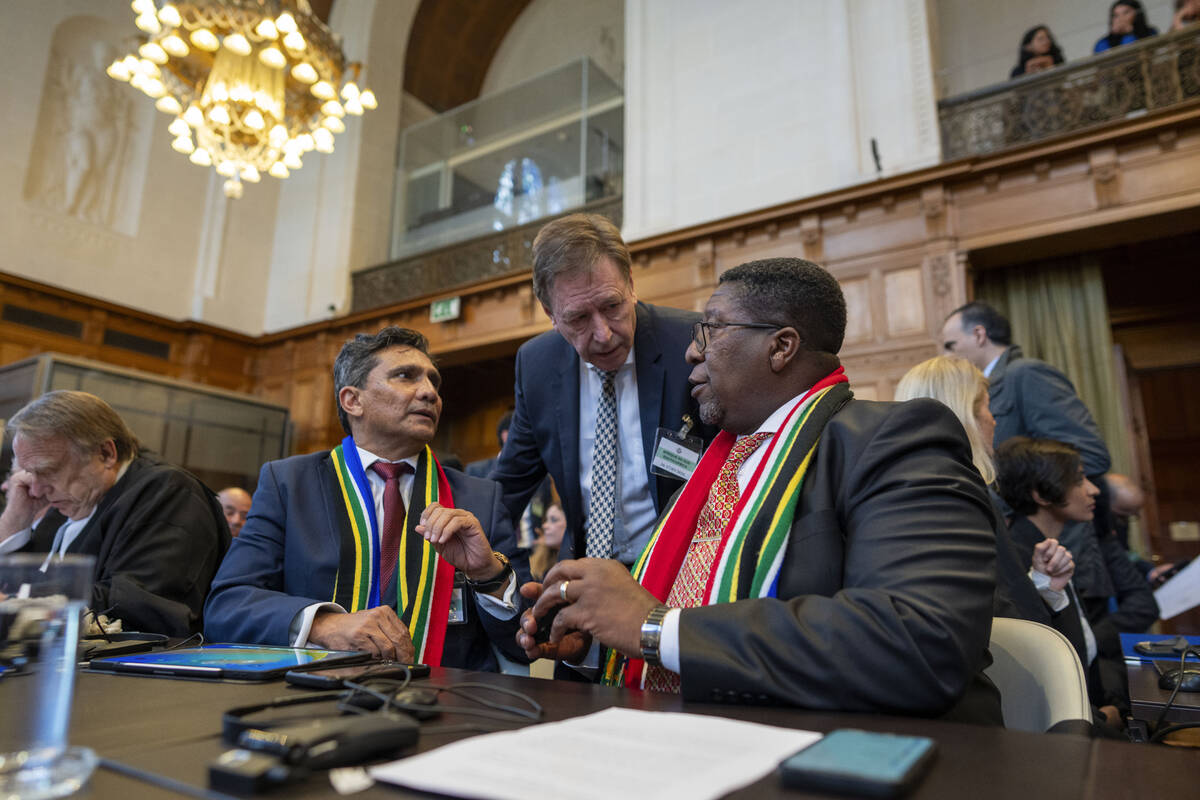 South Africa's agents Vusimuzi Madonsela, seated right, and Cornelius Scholtz, seated second le ...