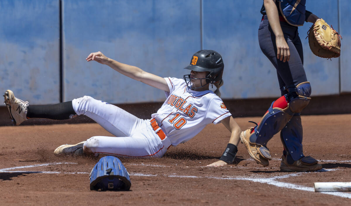 Douglas runner Cam McLelland (10) slides home safely against Coronado during the first inning o ...