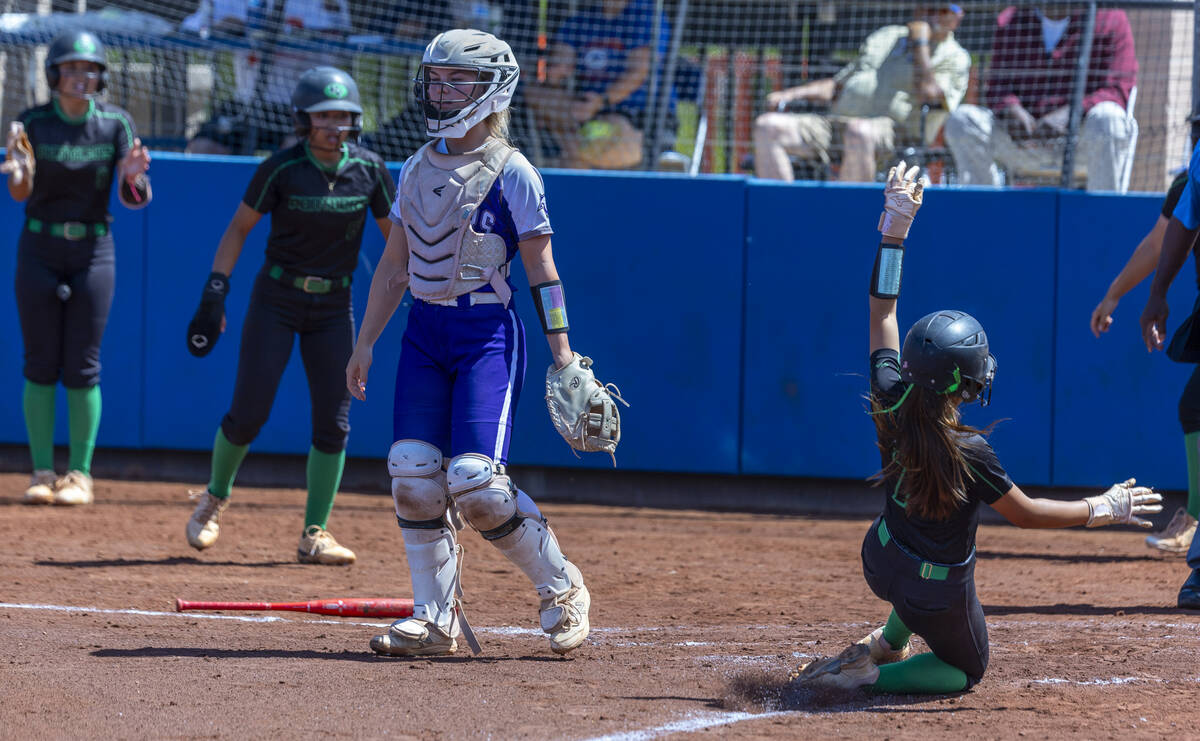 Palo Verde runner Alexis Kearnes (7) slides safely in to home as Spanish Springs catcher Brooke ...