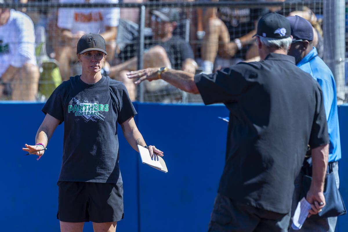 Palo Verde head coach Kelly Glass talks with an official and Spanish Springs head coach Jeff D ...