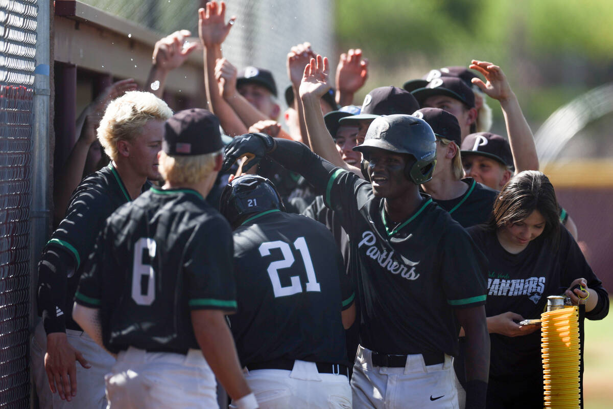 Palo Verde congratulates infielder Tanner Johns (21) after he scored during a Class 5A baseball ...