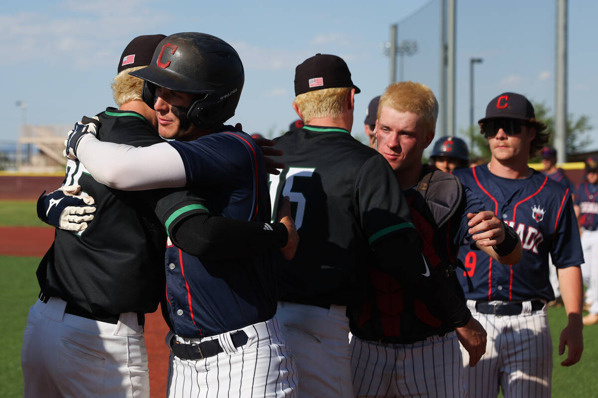 Coronado outfielder Evan Festa (1) hugs Palo Verde infielder Ethan Clauss (25) after a Class 5A ...