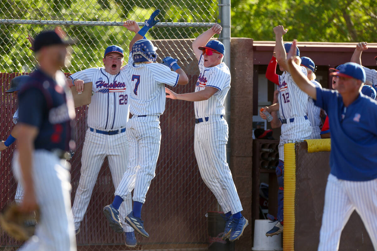 Reno celebrates after scoring during a Class 5A baseball state tournament game against Coronado ...