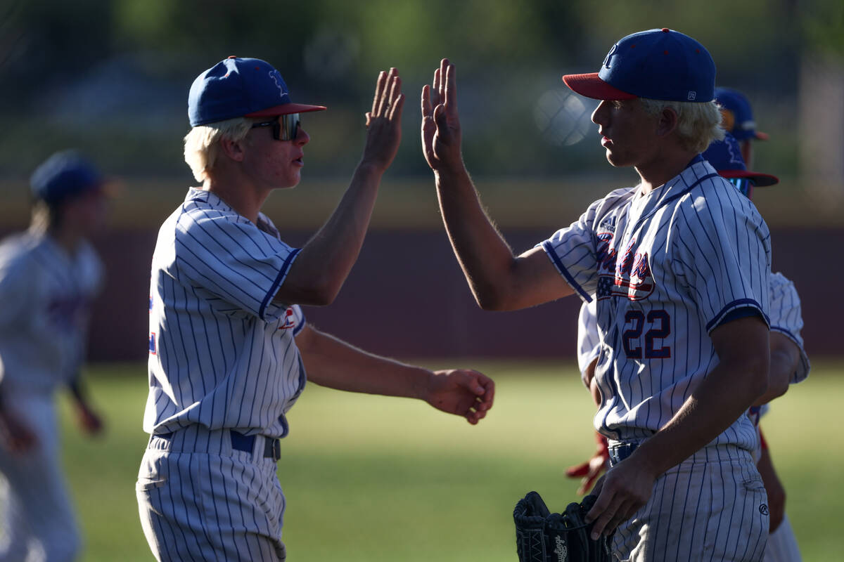 Reno pitcher Mack Edwards is congratulated after closing a Coronado offensive inning during a C ...