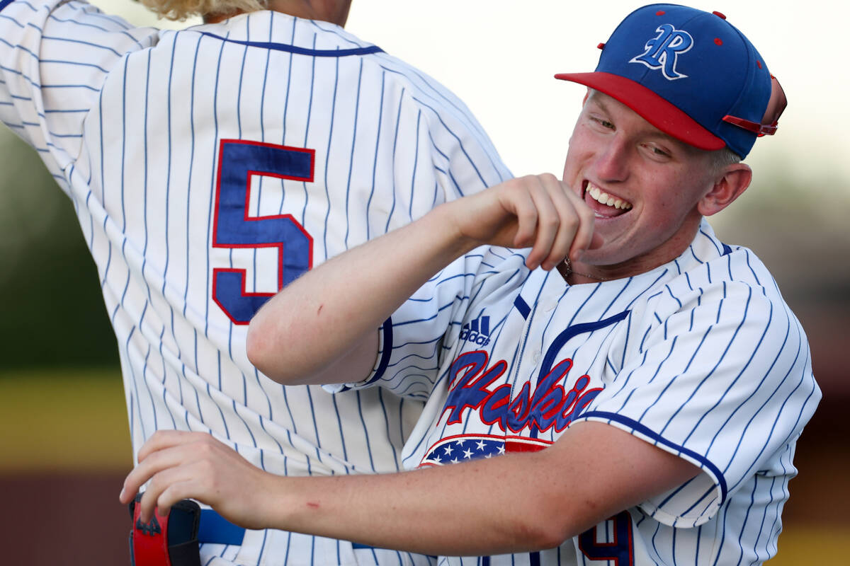 Reno’s Dawson Planeta (5) and Colton Ouellette (9) celebrate a high-scoring inning again ...