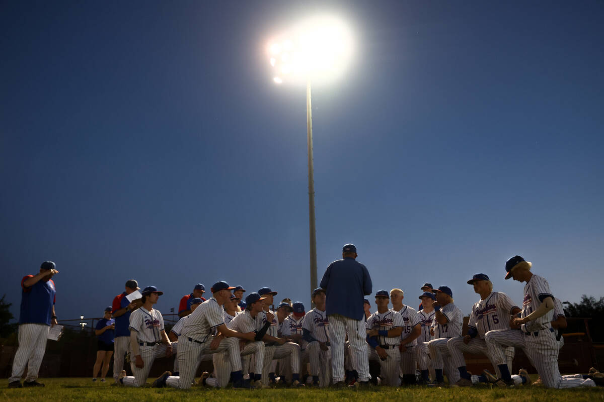 Reno gathers after winning a Class 5A baseball state tournament game against Coronado on Friday ...