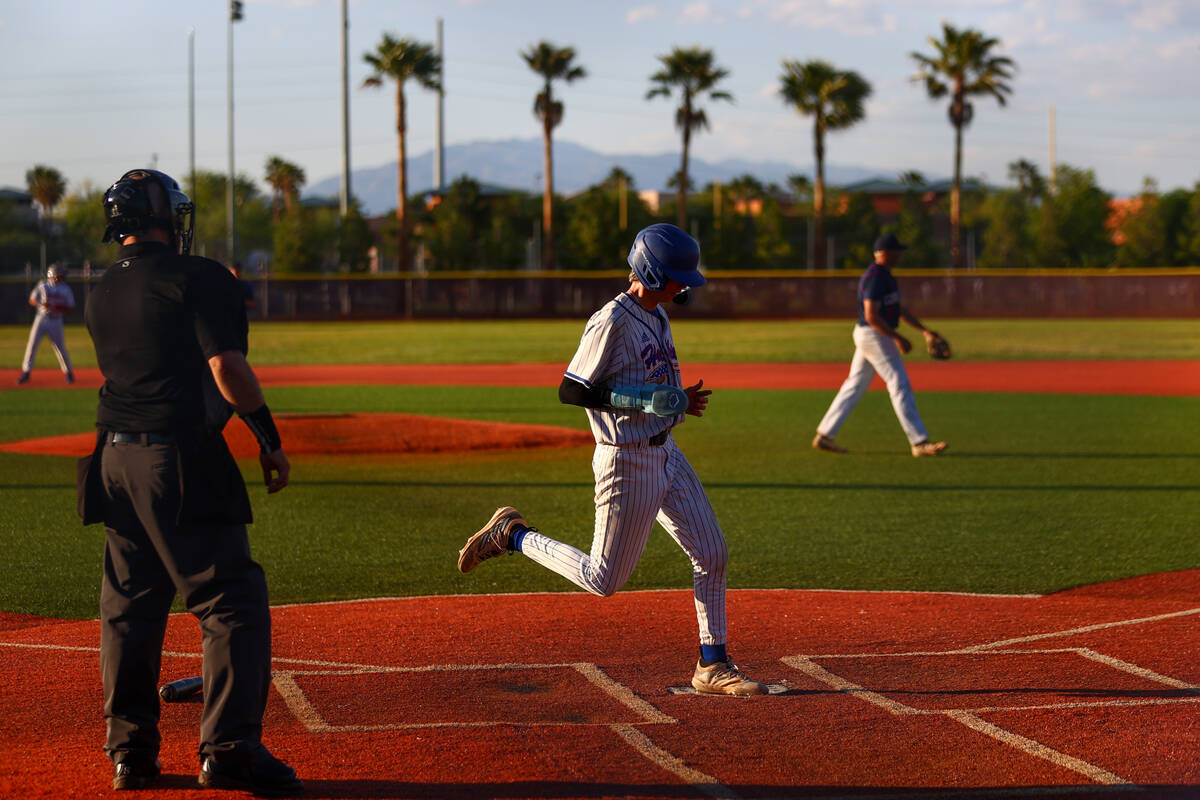 Reno’s Zackary Silverman scores at home plate during a Class 5A baseball state tournamen ...