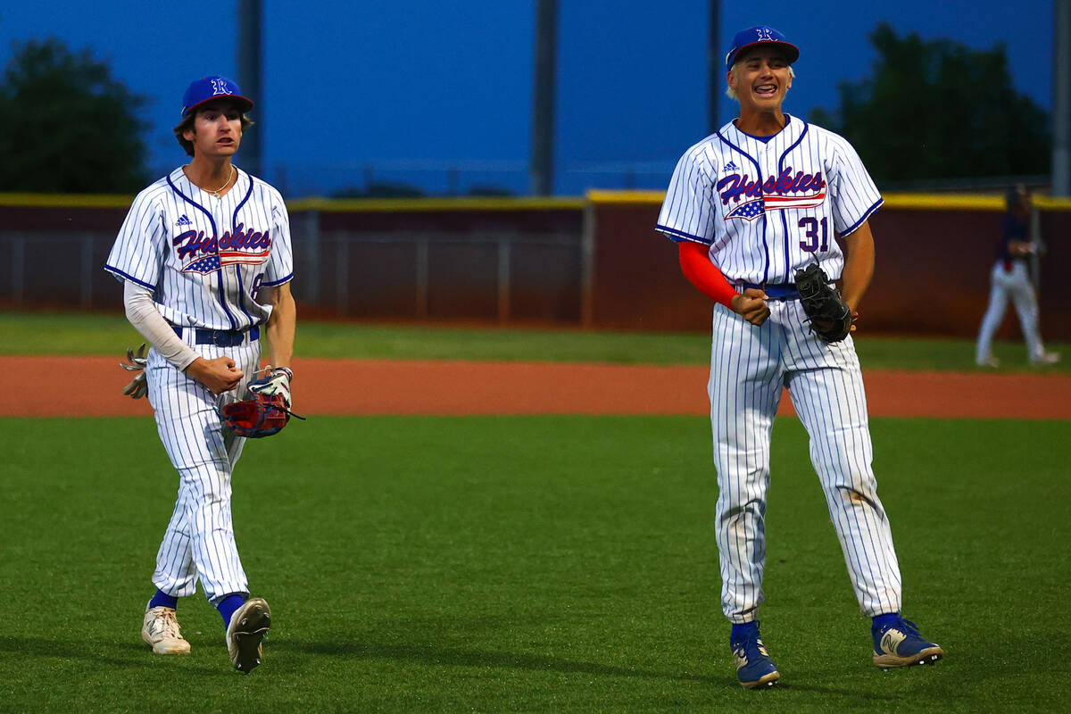 Reno’s Harvey Smerdon (8) and Braden Jones (31) celebrate after winning a Class 5A baseb ...