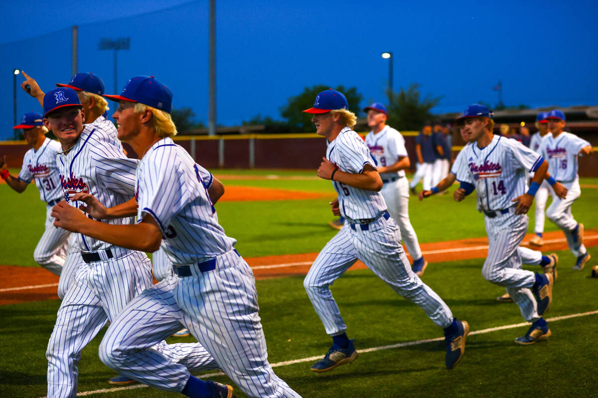 Reno runs to their huddle after winning a Class 5A baseball state tournament game against Coron ...