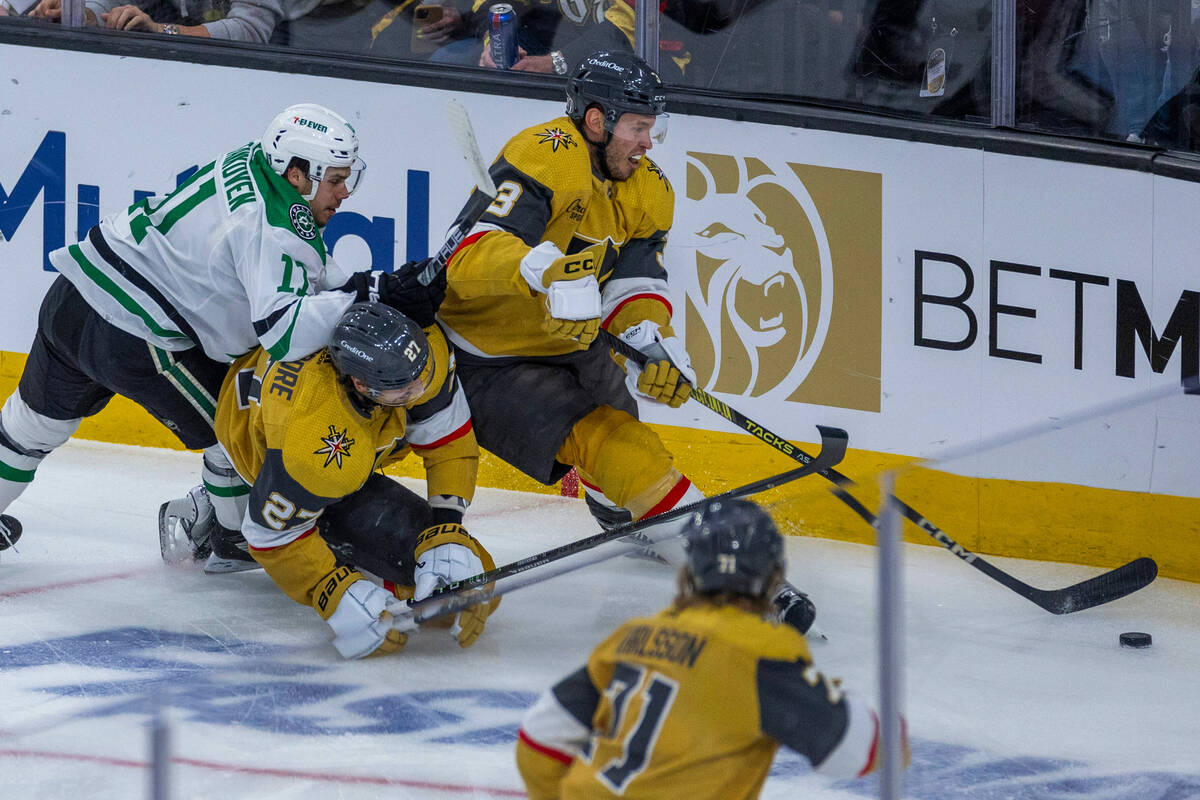 Golden Knights defenseman Brayden McNabb (3) takes control of the puck with help from defensema ...