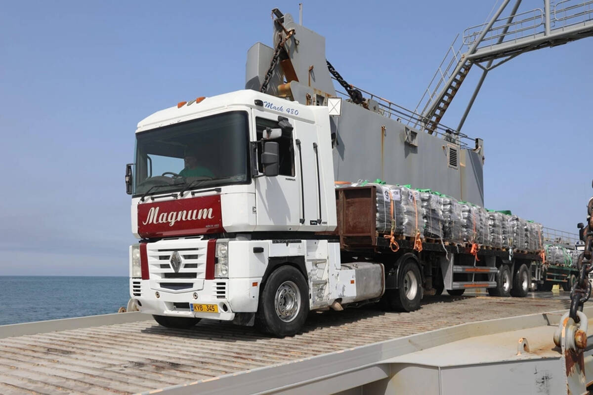 A truck loaded with humanitarian aid from the United Kingdom moves onto the Trident Pier from t ...