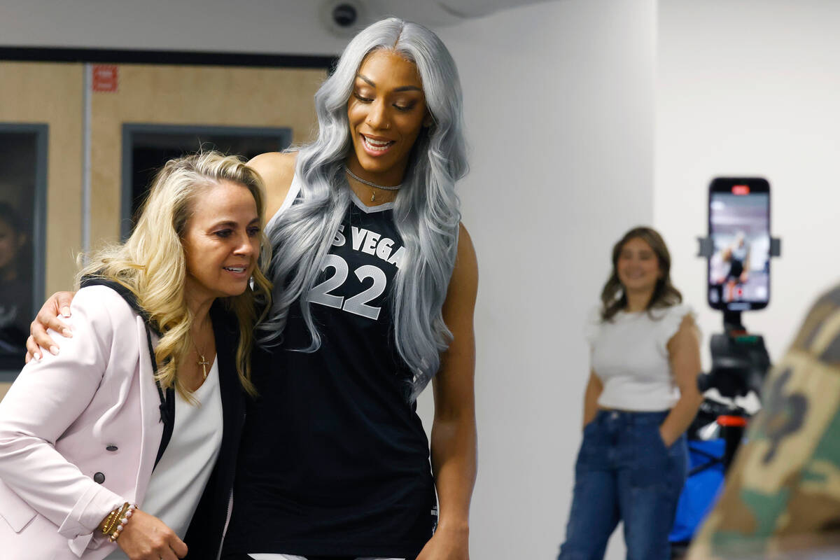 Las Vegas Aces head coach Becky Hammon, left, and center A'ja Wilson (22) greet each other duri ...