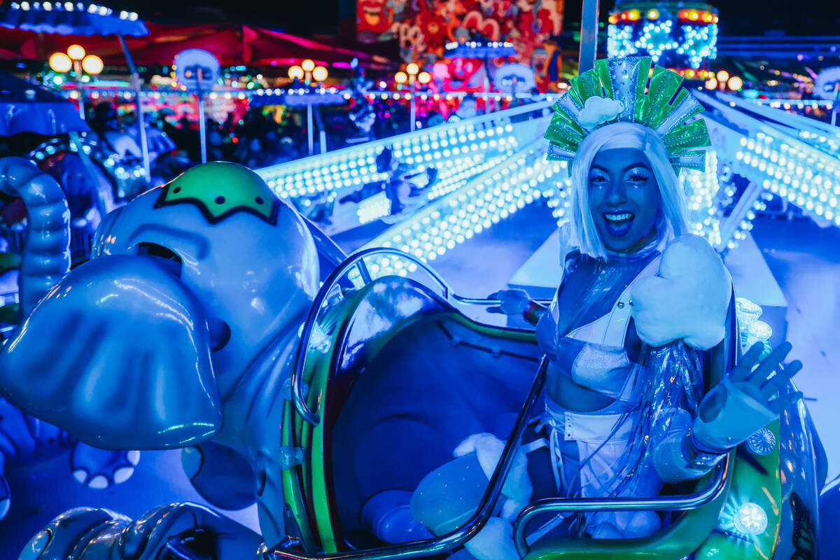 A costumed performer rides an attraction on the third and final night of the Electric Daisy Car ...