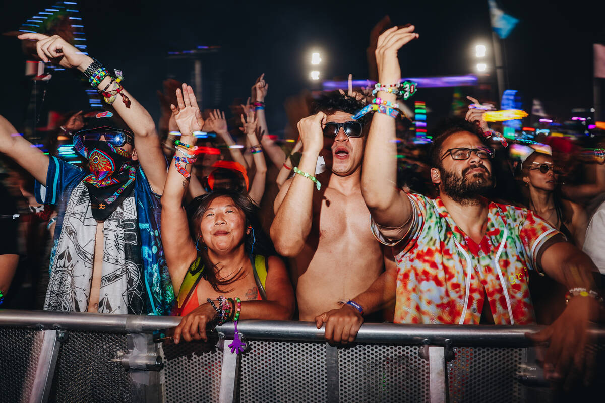 Festival attendees dance to music on the third and final night of the Electric Daisy Carnival a ...