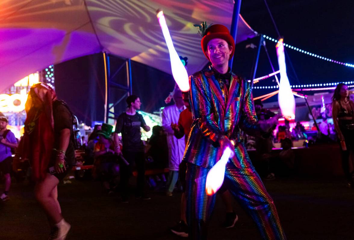 A juggler performs in the Downtown EDC area during the third night of the Electric Daisy Carniv ...