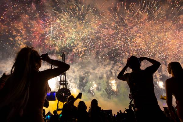 Festival attendees watch as fireworks go off during the third night of the Electric Daisy Carni ...