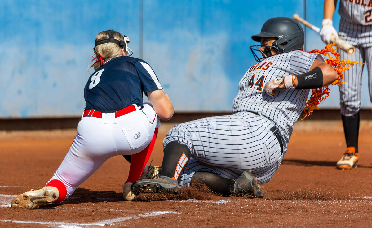 Douglas runner Lilyann Lee (44)attempts to slide into home plate covered by Coronado pitcher Ke ...