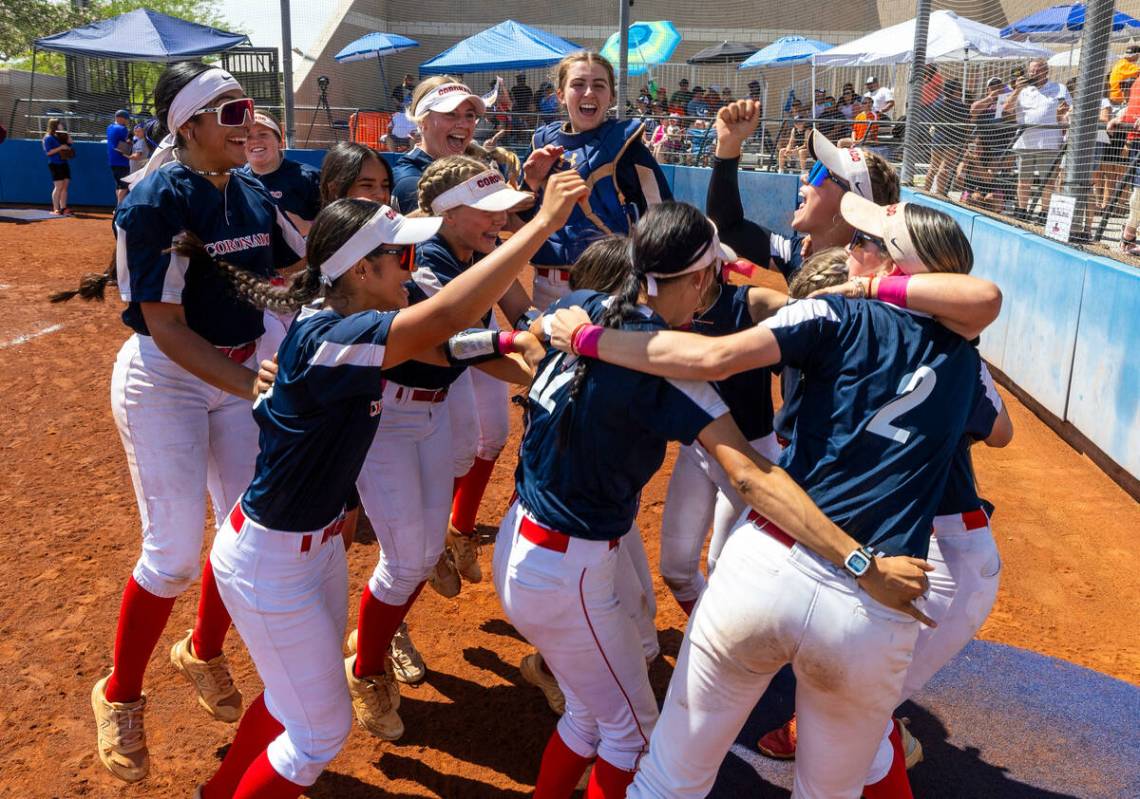 Coronado players celebrate their win over Douglas 4-2 during their 5A softball state tournament ...