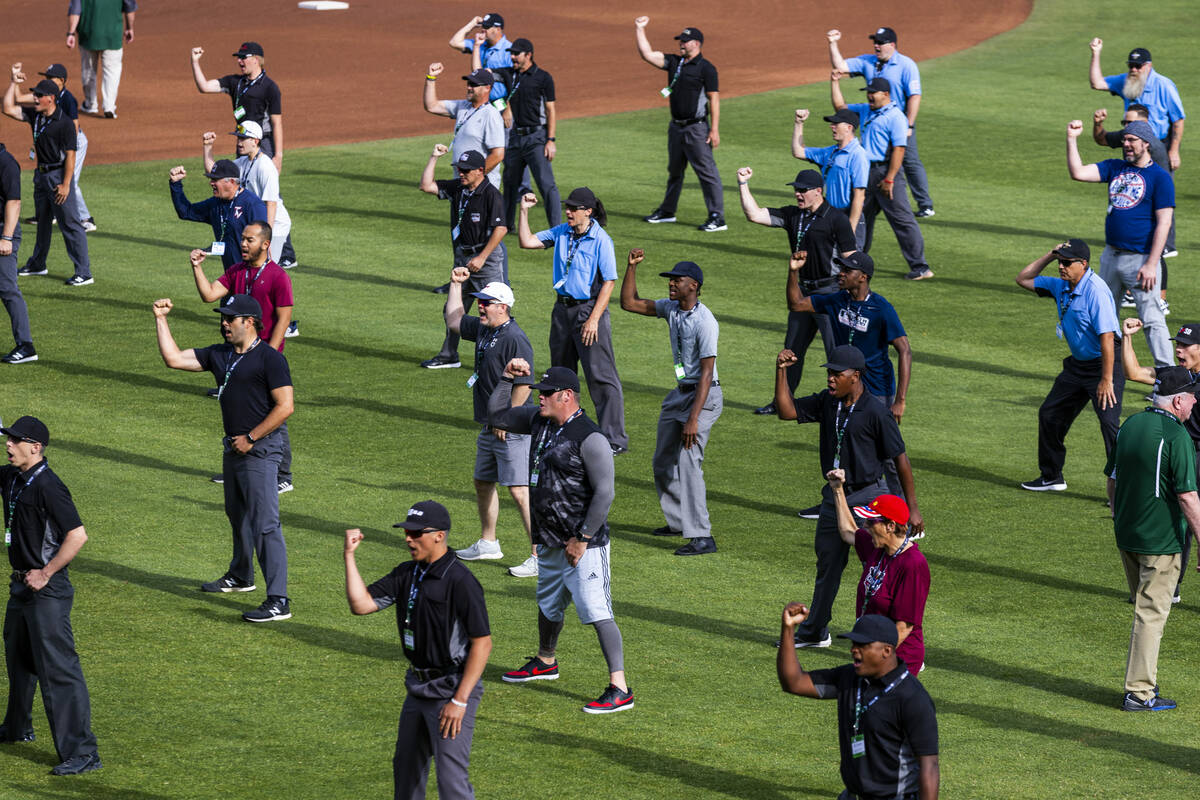 Participants practice their "out" calls for staff during a Major League camp for umpi ...