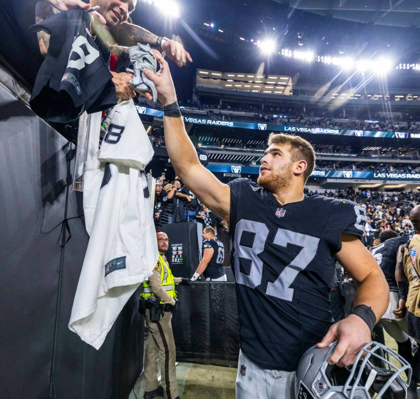 Raiders tight end Michael Mayer (87) gives a fan some gloves after defeating the Los Angeles Ch ...