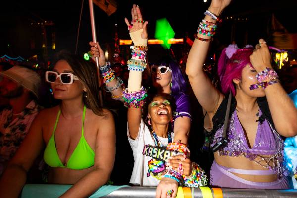Festival attendees dance as Kaskade performs during the third night of the Electric Daisy Carni ...