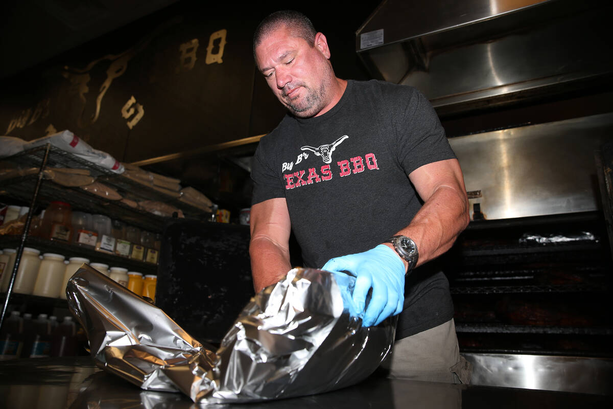 Brian Buechner, co-owner of Big B's Texas BBQ in Henderson, wraps a brisket at his restaurant, ...
