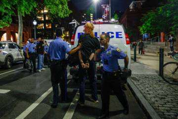 A protester is taken into custody at S. 34th St. near University of Pennsylvania campus in Phil ...