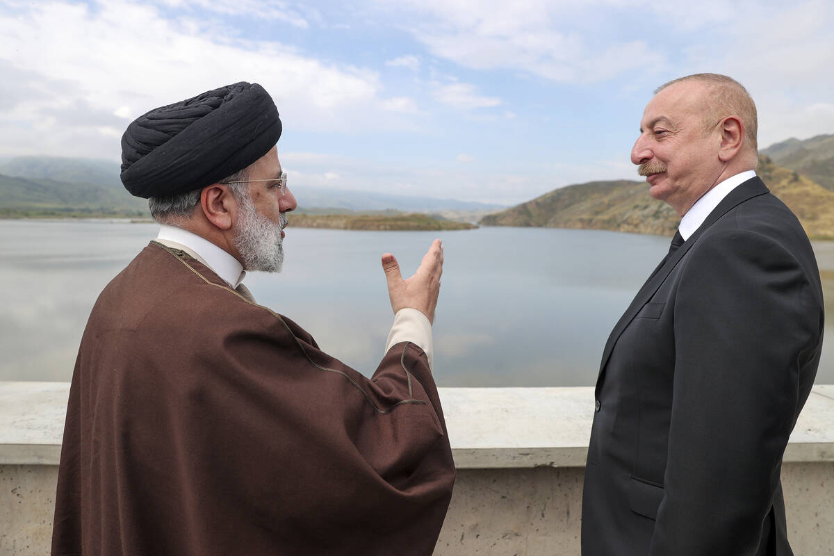 In this photo released by the Iranian Presidency Office, President Ebrahim Raisi, left, speaks ...