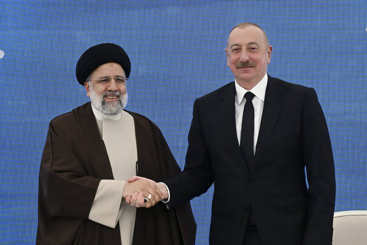 In this photo provided by the Azerbaijan's Presidential Press Office, Iranian President Ebrahim ...