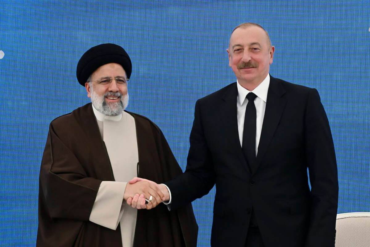 In this photo provided by the Azerbaijan's Presidential Press Office, Iranian President Ebrahim ...