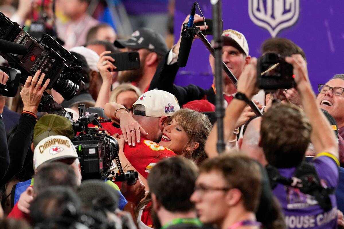 Taylor Swift embraces Kansas City Chiefs tight end Travis Kelce after the NFL Super Bowl 58 foo ...